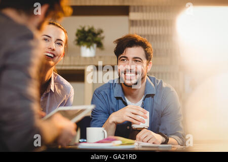 Colleagues using digital tablet at office Stock Photo