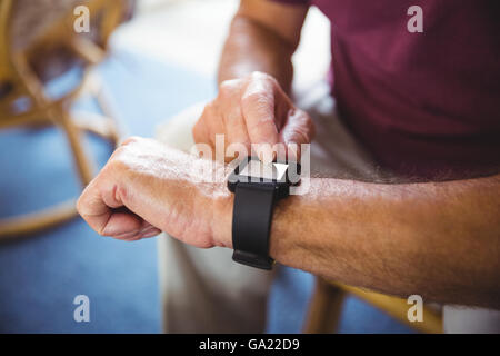 Senior man using a smart watch Stock Photo