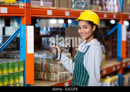 Female warehouse worker using digital equipment Stock Photo