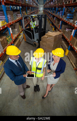 High angle view of managers talking with a worker Stock Photo