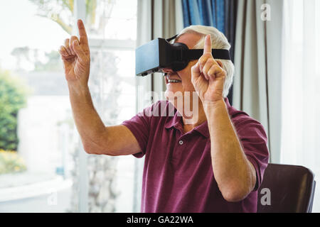Senior man using a virtual reality device Stock Photo