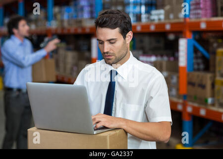 Standing business man working on computer Stock Photo