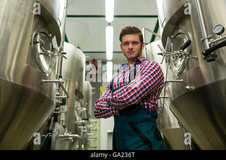Brewer with arms crossed at brewery Stock Photo