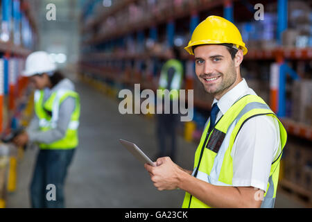 Worker in warehouse looking at camera Stock Photo