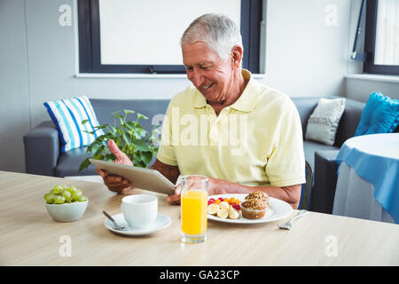 Senior man using a digital tablet Stock Photo