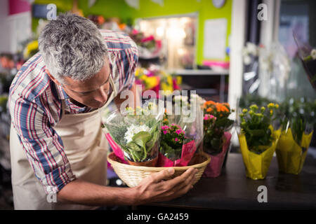 Male florist arranging bouquet of flower Stock Photo