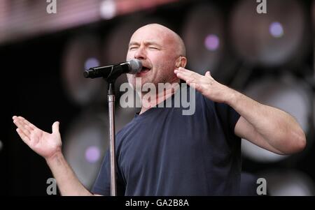 Phil Collins on stage during Genesis' performance at the charity concert at Wembley Stadium, London. Stock Photo