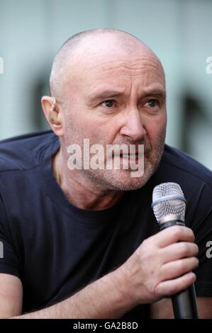 Phil Collins on stage during Genesis' performance at the charity concert at Wembley Stadium, London. Stock Photo
