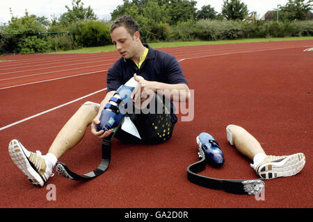 Double-amputee Oscar Pistorius puts on his running shoes at Brunel University, Uxbridge, London. Stock Photo