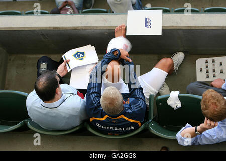 LA Galaxy's David Beckham (centre) sits with personal his manager Terry Burn (right) as his ankle is put in ice whilst he watches the team in action during a Friendly match at The Home Depot Center, Los Angeles, USA. Stock Photo