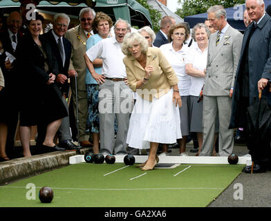 Britain's Prince Charles, the Prince of Wales, (second right) looks on as his wife Camilla, Duchess of Cornwall, tries her hand at bowling during a visit to the village of Bromham in Wiltshire. Stock Photo