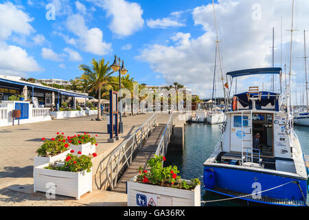 PUERTO CALERO MARINA, LANZAROTE ISLAND - JAN 17, 2015: boats in Puerto Calero port built in Caribbean style. Many tourists spend vacation here. Stock Photo