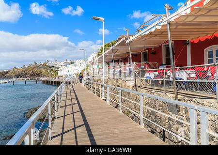 Coastal promenade with restaurant building on side in Puerto del Carmen port, Lanzarote, Canary Islands, Spain Stock Photo