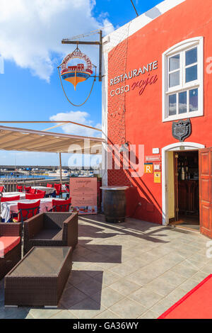 PUERTO DEL CARMENT PORT, LANZAROTE - JAN 17, 2015: entrance to red restaurant building in Puerte del Carmen port. This town is popular holiday destination on Lanzarote island. Stock Photo