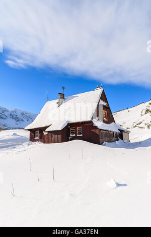 Wooden mountain hut in winter landscape of Gasienicowa valley, Tatra Mountains, Poland Stock Photo