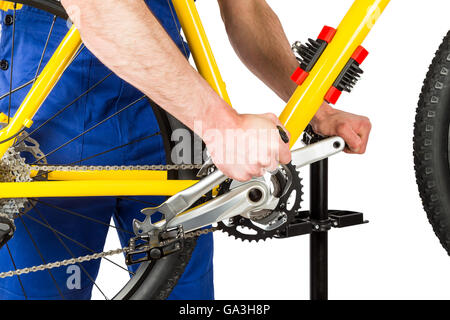 bicycle mechanic tightening pedal on mountain bike Stock Photo