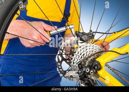 mounting brake caliper on yellow mountain bike Stock Photo
