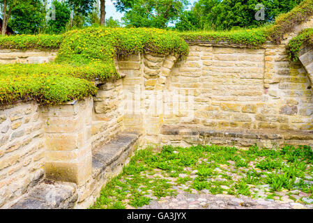 Vreta, Sweden - June 20, 2016: Part of the old ruins after the monastery building behind the church. Limestone and vegetation on Stock Photo