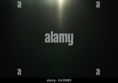 real green lens flare over dark background Stock Photo