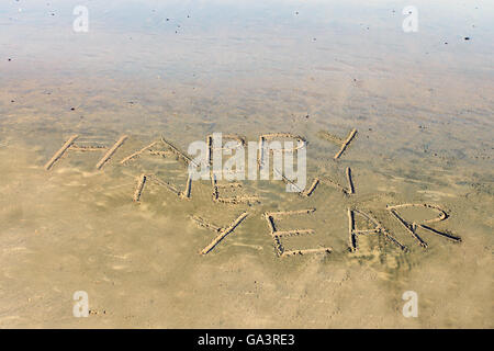 Happy new year written on sand. Welcome to new year. Stock Photo