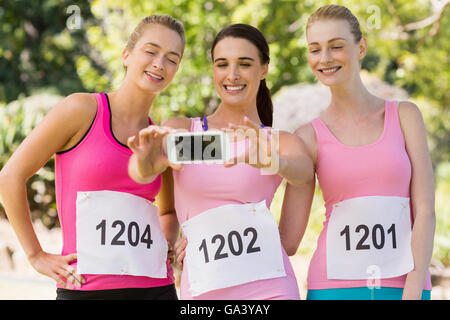 Young athlete women taking photo from mobile phone Stock Photo