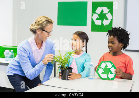 Teacher and kids discussing about recycle Stock Photo