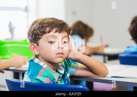 Thoughtful boy looking away while studying Stock Photo