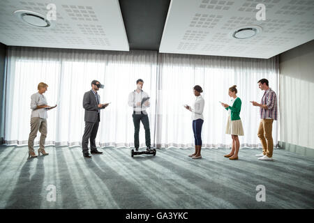 Business people using electronic gadgets Stock Photo