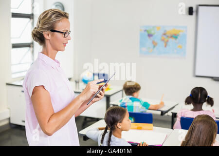 Teacher using digital tablet Stock Photo