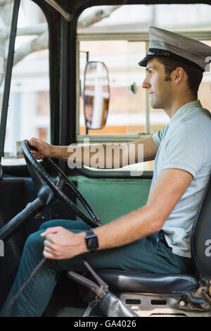 Bus driver driving a bus Stock Photo