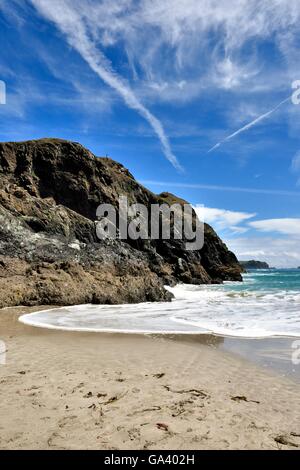 An incoming wave on the beach at Kynance cove Cornwall England UK Stock Photo