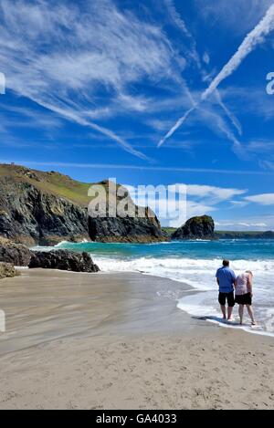 A couple paddling in the sea at Kynance cove Cornwall England UK Stock Photo