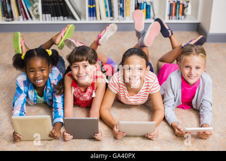 Kids using digital tablet in library Stock Photo