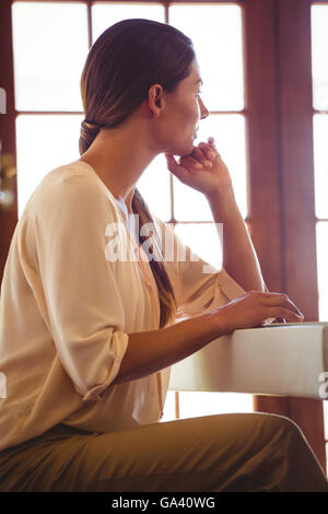 Woman touching her chin Stock Photo