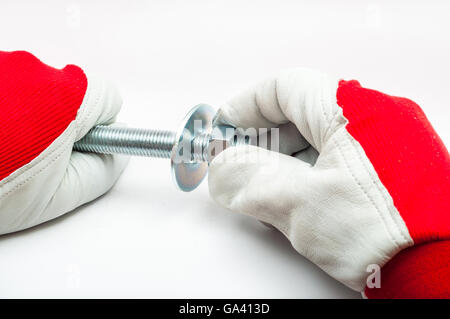 Screwing bolt by hand on white background Stock Photo
