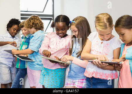 Students using digital tablet in classroom Stock Photo