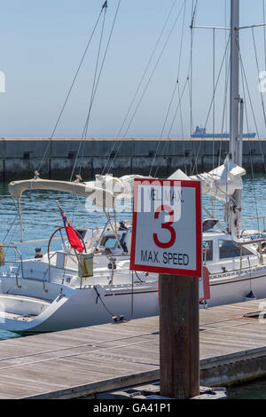 yachts in coast marine around sign of speed limit in summer day Stock Photo