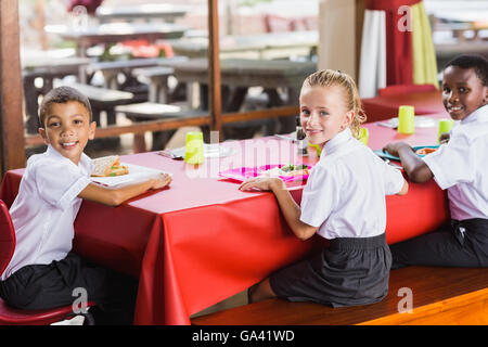 Children having lunch during break time in school cafeteria Stock Photo