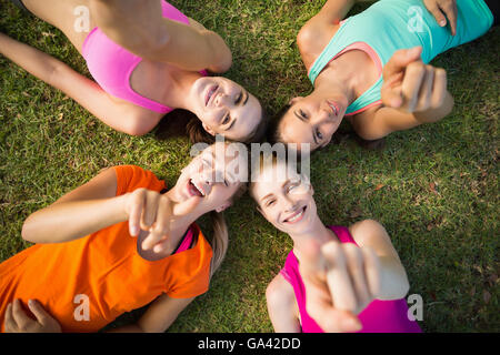 Beautiful young women lying and pointing Stock Photo