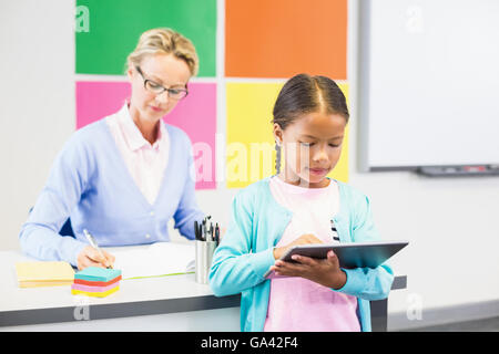 Schoolgirl using digital tablet in classroom Stock Photo