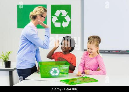 Teacher and kids giving high five to kids Stock Photo