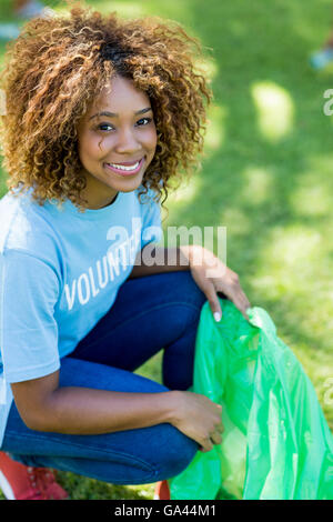 Portrait of volunteer woman collecting rubbish Stock Photo