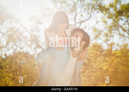 Man giving woman piggyback ride Stock Photo