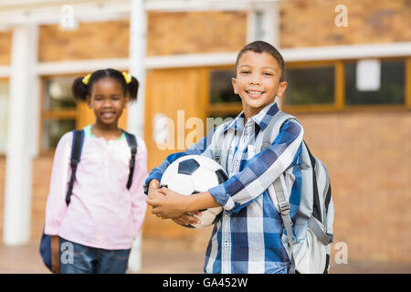 Smiling kids standing in classroom at school Stock Photo
