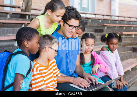 Teacher and kids using digital tablet Stock Photo