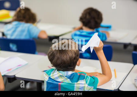 Rear view of pupil a paper plane Stock Photo