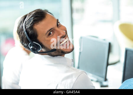 Young man working on computer with headset Stock Photo