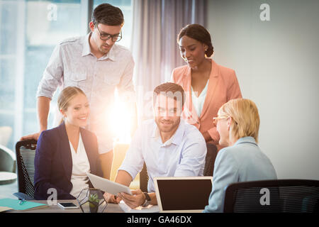 Group of business people interacting using digital tablet Stock Photo