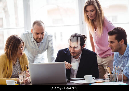 Business people using laptop during meeting Stock Photo