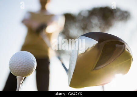 Focus on foreground of golf club and ball Stock Photo